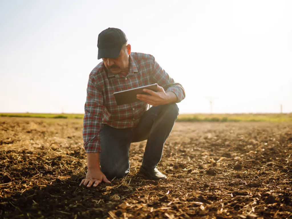 Farmer in field with tablet