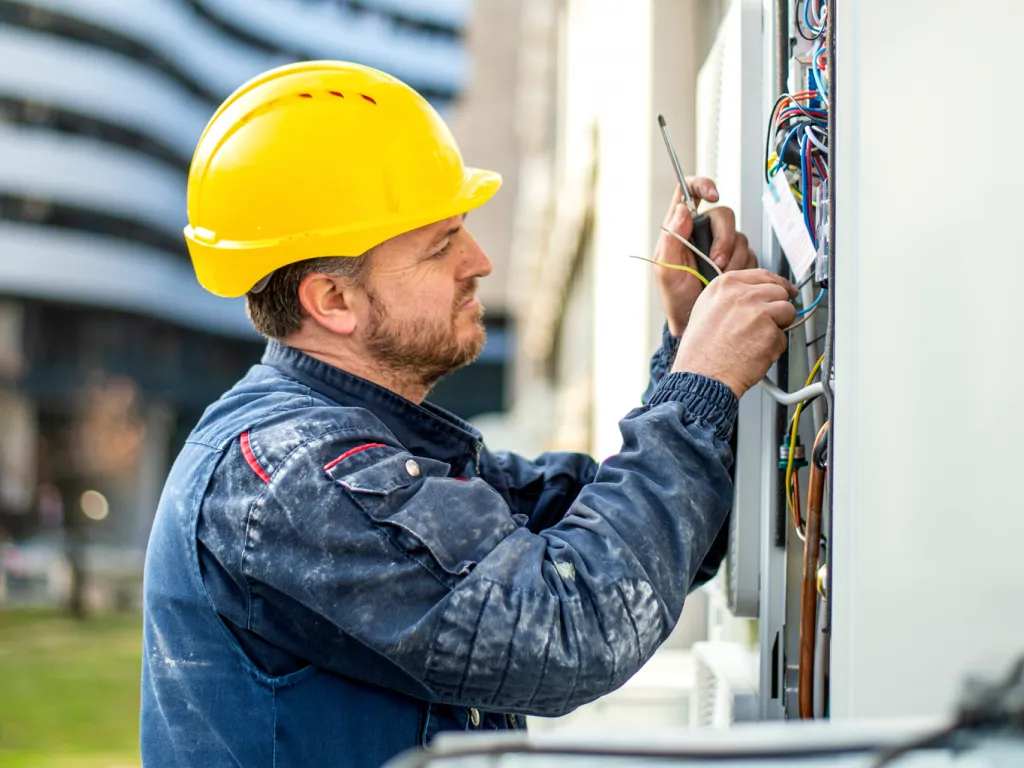 Employee working on heating/cooling system